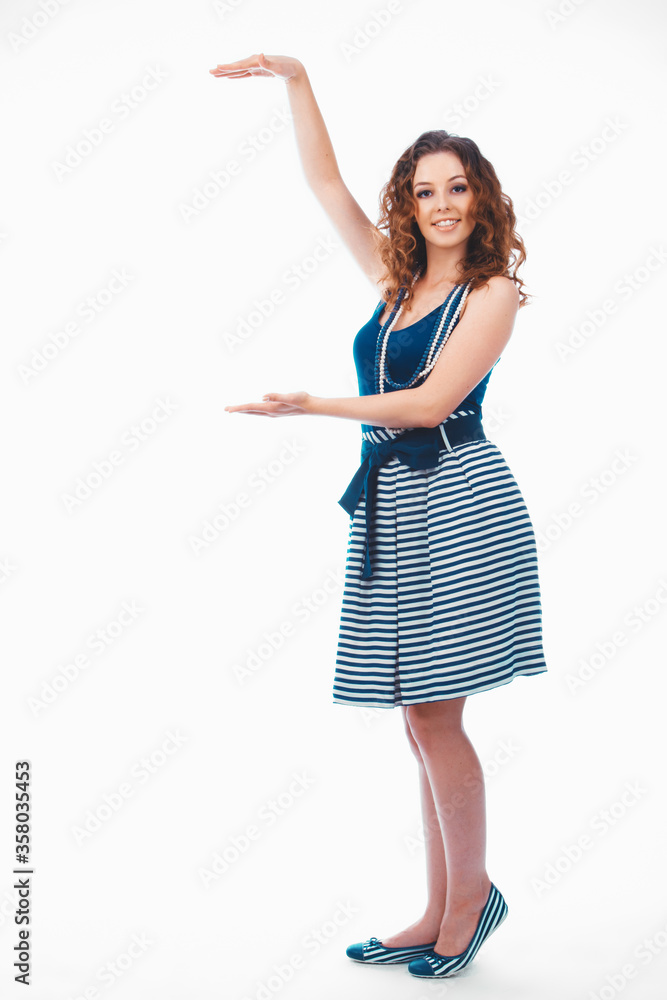 Smiling happy brunette woman pointing with finger and showing size, isolated on white Smiling happy brunette woman pointing with finger and showing size, isolated on white