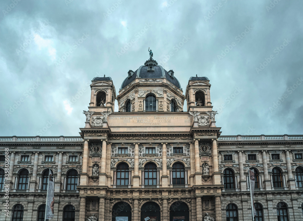 Obraz premium Hoffburg Imperial Palace in Vienna, Austria. Luxurious baroque facade and gloomy rainy sky