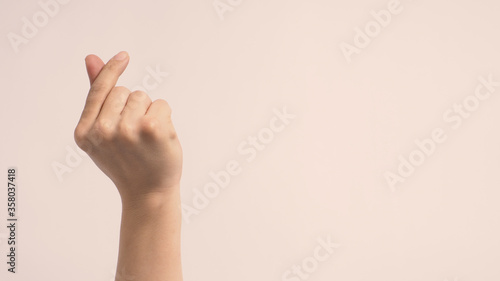 Mini heart hand sign on white background. photo