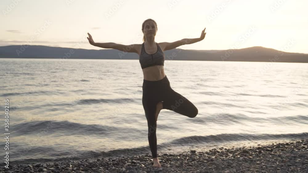 Young woman practicing yoga on the background of a beautiful blue lake. Fitness, sport, yoga and healthy lifestyle concept. Young woman practicing yoga on the background of a beautiful blue lake. Fitness, sport, yoga and healthy lifestyle concept.