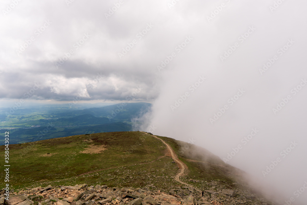 Mountain trail leading over ridge of fog, slovakia poland Babia gora