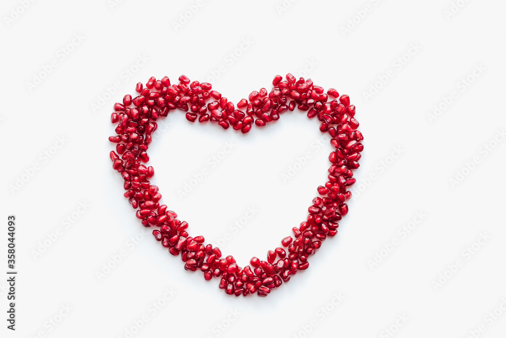 heart of beads, pomegranate heart, pomegranate seeds on white background