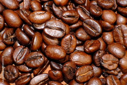 Fototapeta Naklejka Na Ścianę i Meble -  Blurred coffee beans on wood table and macro coffee beans background