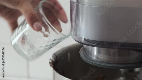 Add water to a working cooking mixer.