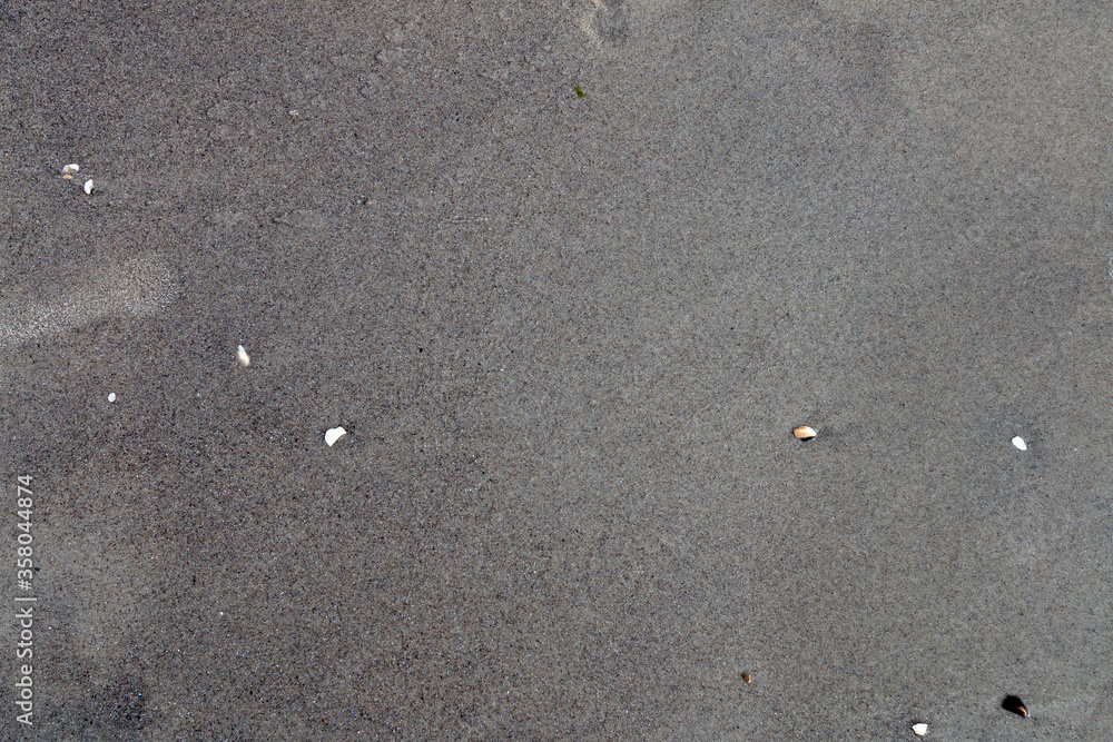 Gray background, texture of wet coastal sand. Gray background, texture of wet coastal sand.