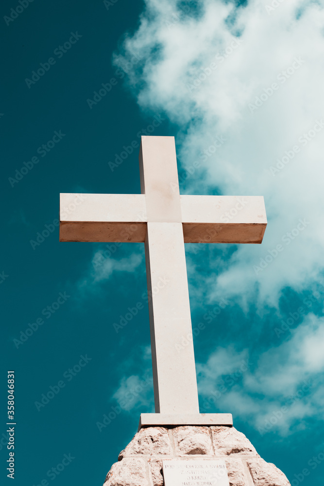 Huge white modern cross on the hill near town of Stargrad, island of Hvar in Croatia Huge white modern cross on the hill near town of Stargrad, island of Hvar in Croatia