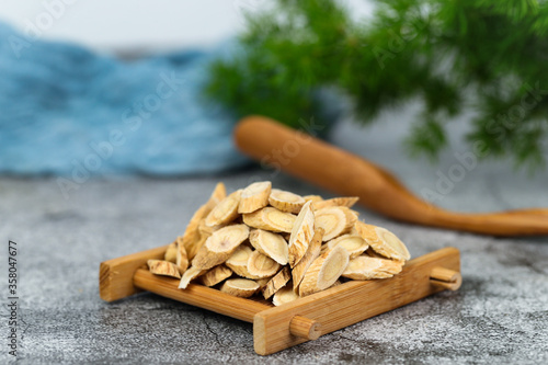 Chinese herbal medicines -- Astragalus on stone background photo