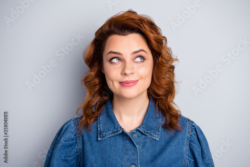 Closeup photo of pretty curly foxy lady look up empty space dreamer person thinking over creative idea wear casual blue jeans denim shirt isolated grey color background © deagreez