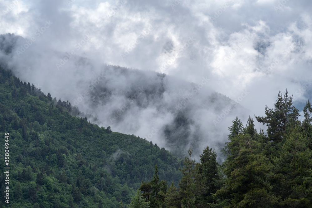 Fog revealing the mountain range after rain