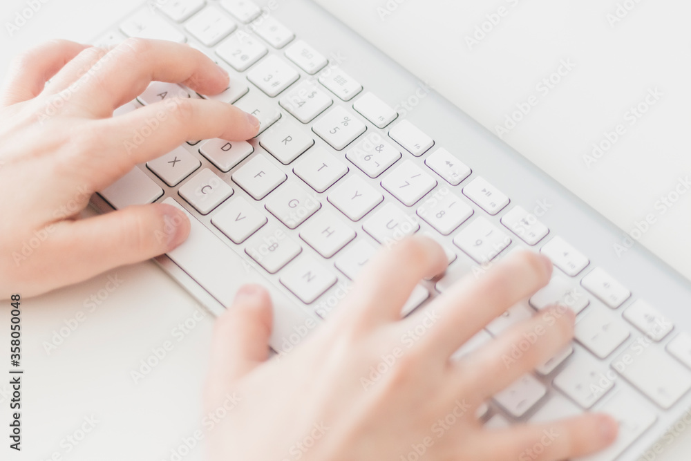Close up, Caucasian woman typing on a wireless keyboard. Business woman, selective focus, concepts Close up, Caucasian woman typing on a wireless keyboard. Business woman, selective focus, concepts
