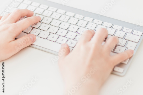 Close up, Caucasian woman typing on a wireless keyboard. Business woman, selective focus, concepts