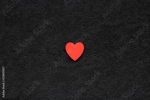 red heart in the middle of black background. Concept of love. Valentine's day background.