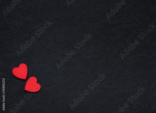 two red hearts in the corner of black background. Concept of love. Valentine's day background.