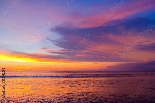 Colourful sunset, red-orange clouds on sea horizon background.