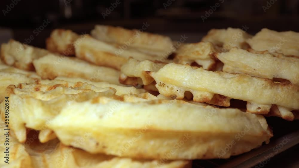 Stack of fresh golden waffles hot and ready to eat - sliding isolated close up Stack of fresh golden waffles hot and ready to eat - sliding isolated close up