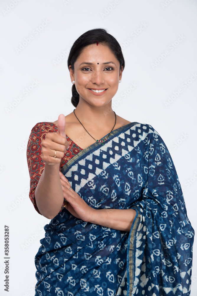 Pretty Indian young woman showing thumbs up.