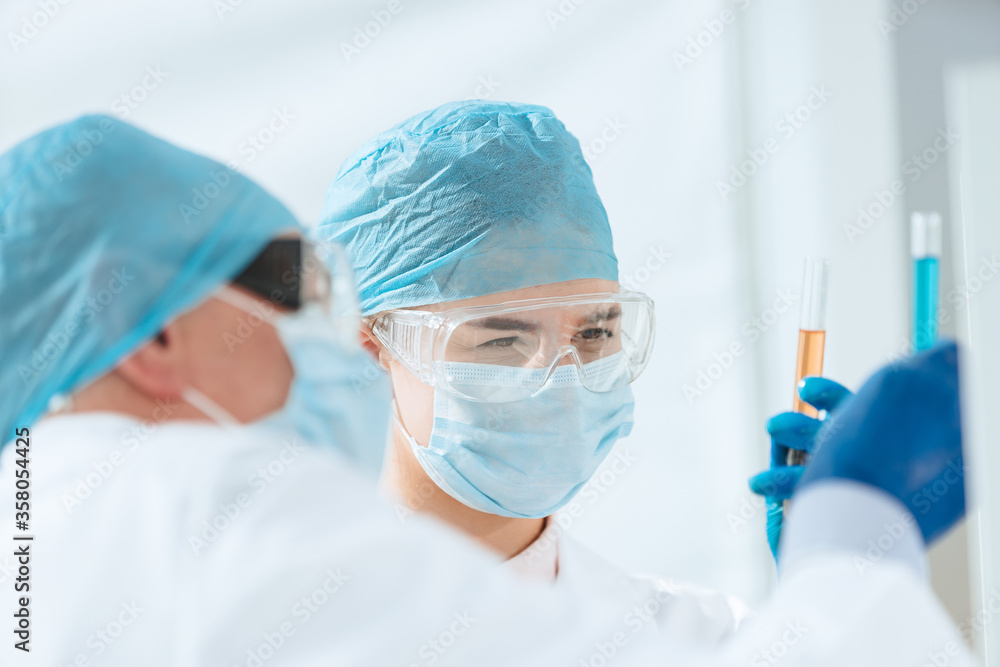 close up. scientists compare liquids in test tubes. close up. scientists compare liquids in test tubes.