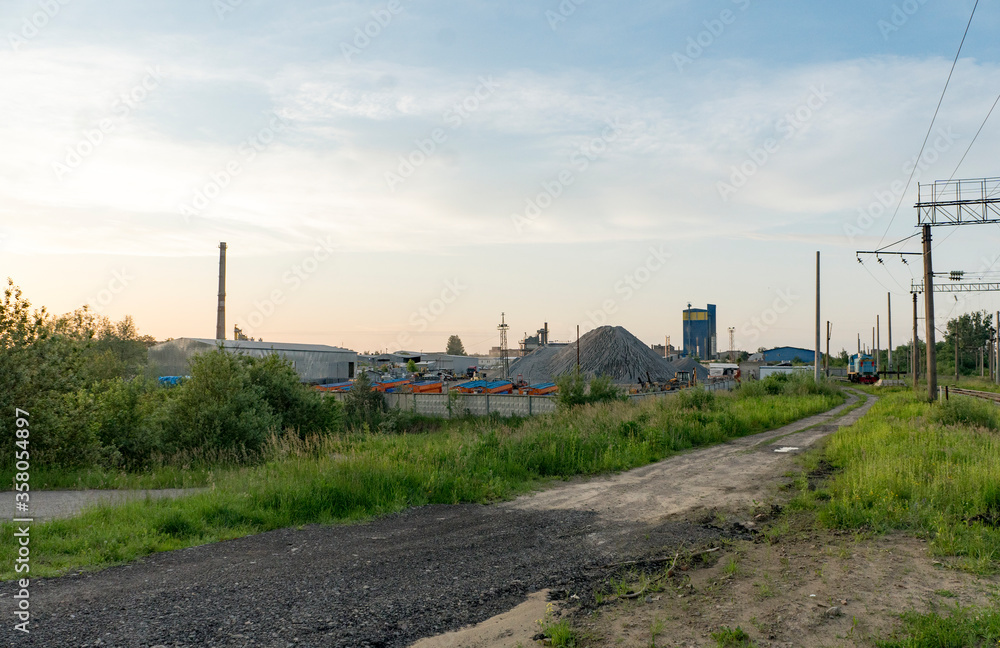 A large cement plant in the country near the railway. Pipes, tanks, trucks, tractors. A large cement plant in the country near the railway. Pipes, tanks, trucks, tractors.