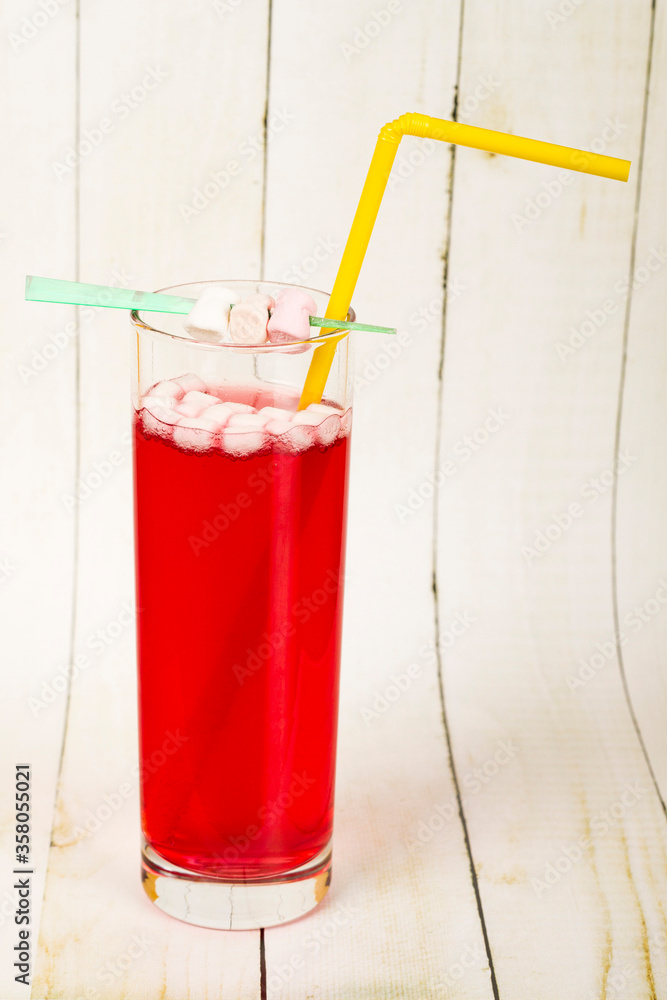 Glass of red lemonade with marshmallows side view
