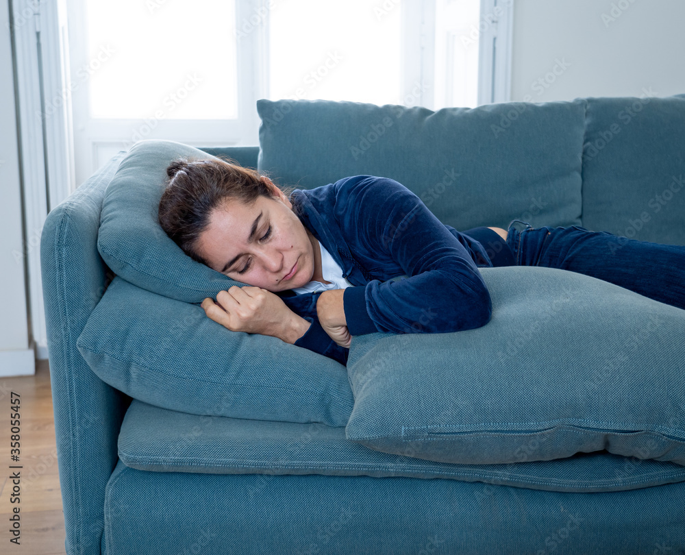 Young sad woman suffering from depression feeling lonely and hopeless isolated at home Young sad woman suffering from depression feeling lonely and hopeless isolated at home