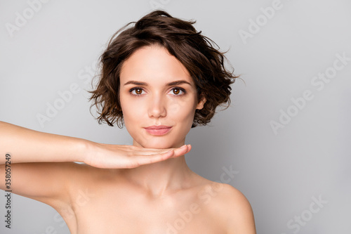 Closeup photo of beautiful naked lady bobbed short hairstyle look mirror reflection hold hand under chin good operation result isolated grey color background