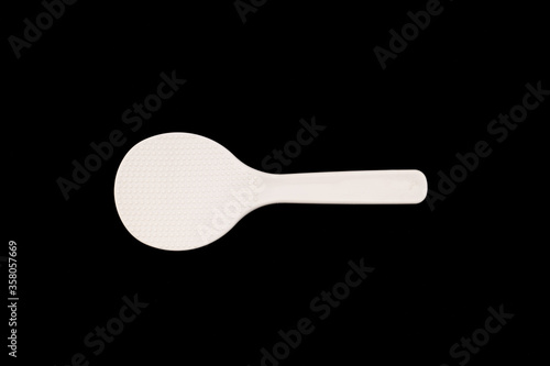White Plastic ladle on black background