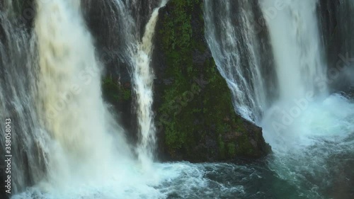 Strong torrents of water cascading down Burney Falls into the deep pool at its base, California, USA. photo