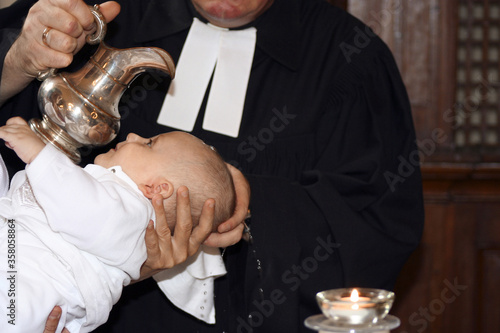 Obraz na plátne Baby being baptized