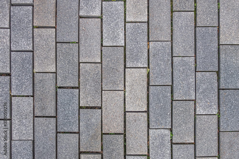 abstract background of the pavement lined with granite tiles close up abstract background of the pavement lined with granite tiles close up