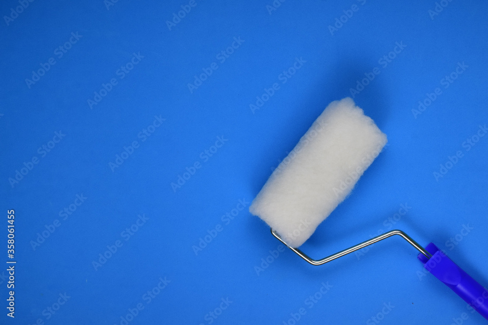 Paint utensil on blue background, space for text Paint utensil on blue background, space for text