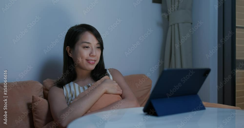 Woman watch on tablet computer at night Woman watch on tablet computer at night
