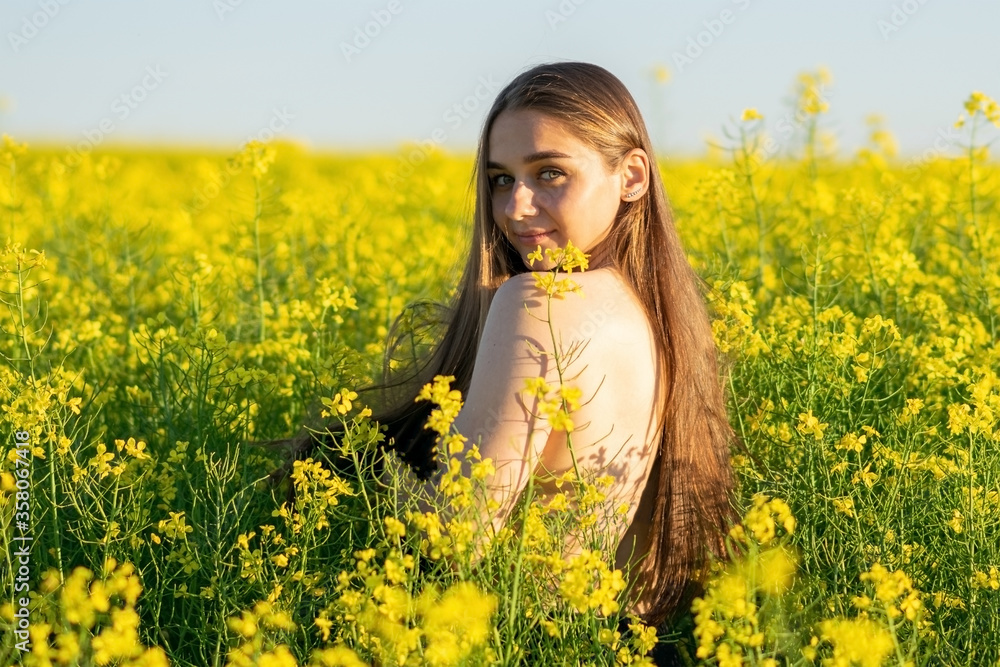 Beautiful girl in a rapeseed field, with an open shoulder. Beautiful girl in a rapeseed field, with an open shoulder.