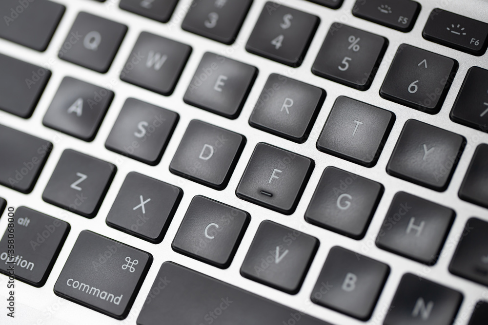 close up modern laptop, stylish computer keyboard the area. The flat trackpad can be seen in the frame. focus notebook characters. close up modern laptop, stylish computer keyboard the area. The flat trackpad can be seen in the frame. focus notebook characters.