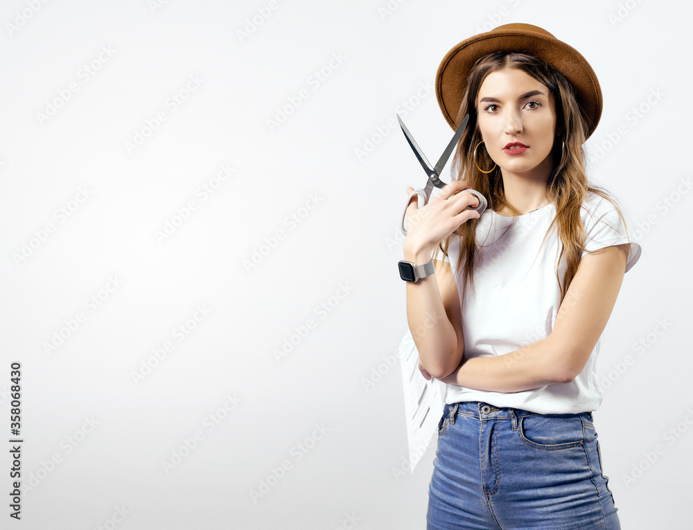 A woman wearing a hat looking with scissors A woman wearing a hat looking with scissors
