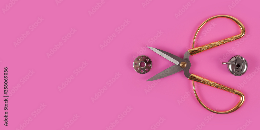 sors and spools of thread on pink background sors and spools of thread on pink background