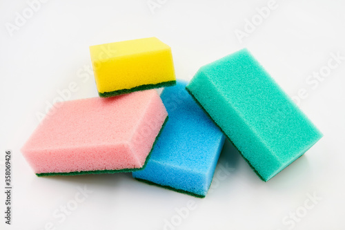 Set of multi-colored foam cleaning sponges for washing dishes, cleaning the bathroom and other household needs on a white background. Closeup
