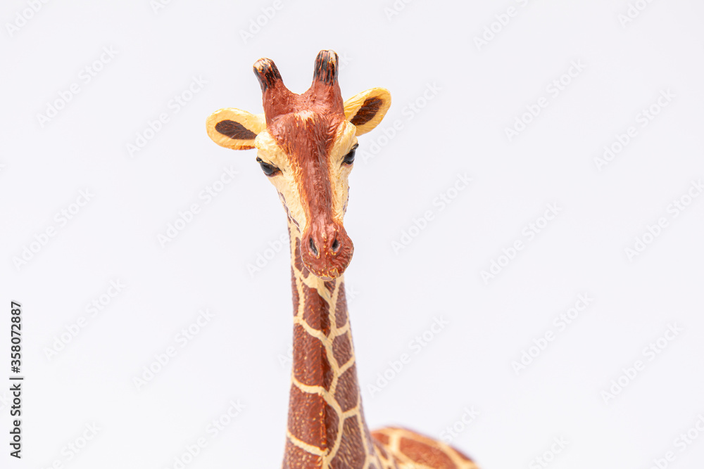 close up of a giraffe made from plastic isolated on a white background