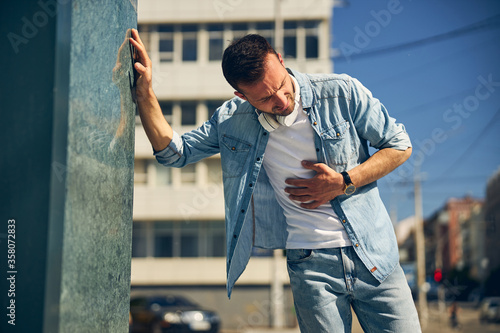 Close up of young man that having stomachache