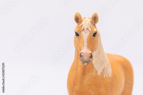 close up of a brown plastic horse head isolated on a white background