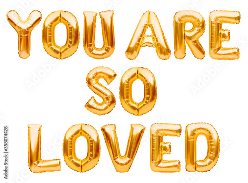Golden words YOU ARE SO LOVED made of inflatable balloons isolated on white background. Gold foil helium balloon letters, love message, balloons lettering