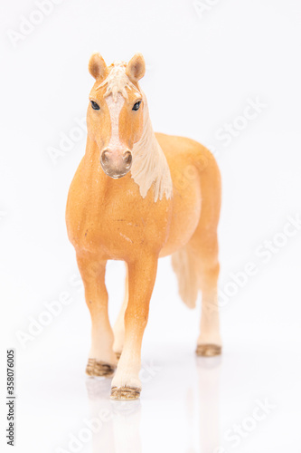 Fototapeta Naklejka Na Ścianę i Meble -  close up of a brown plastic horse head isolated on a white background