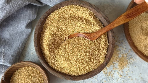 Raw Amaranth seeds in a bowl with a spoon close up
