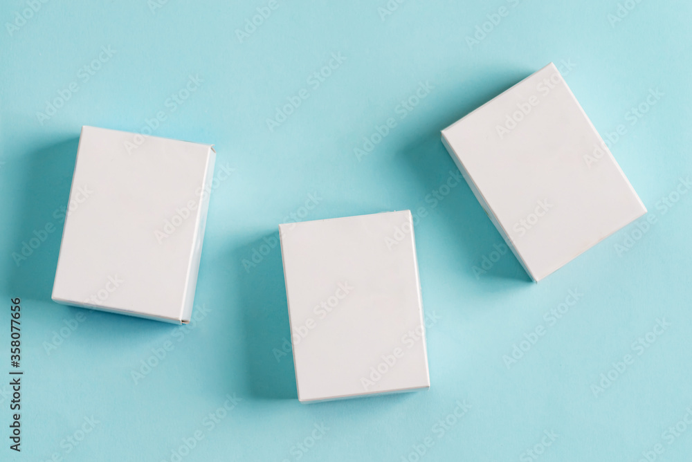 Set from three paper mock up boxes for packaging products and things on a pastel blue background. Set from three paper mock up boxes for packaging products and things on a pastel blue background.