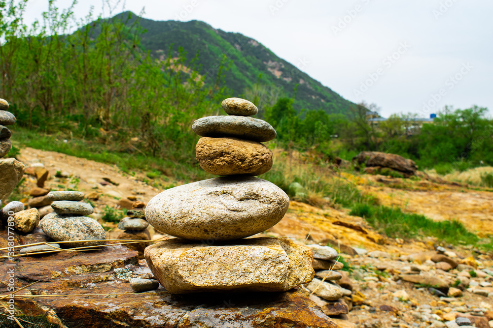A stone stack from Wolyubong in Yeongdong County, Kore against a gorgeous, blurred scenic background. A stone stack from Wolyubong in Yeongdong County, Kore against a gorgeous, blurred scenic background.
