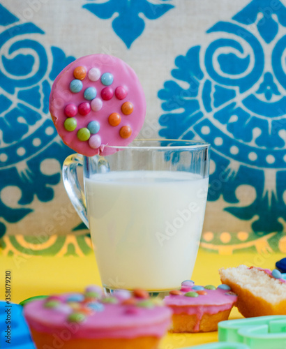 A glass of milk and cookies with colorful sprinkles  photo