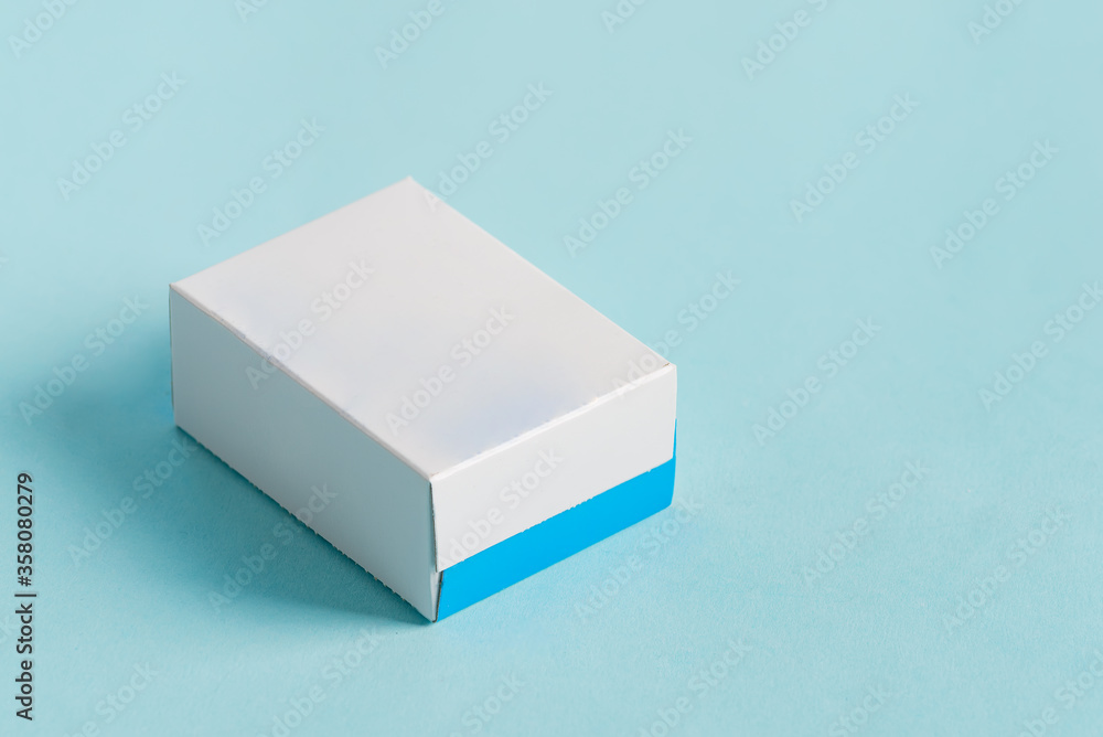 Handmade mock up paper box for package products and goods on a light blue background with soft shadows. Handmade mock up paper box for package products and goods on a light blue background with soft shadows.