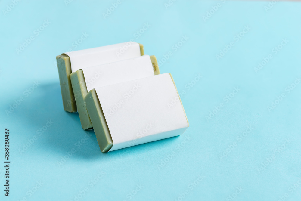 Set from handmade herbal natural soap bar on a pastel blue background. Mock-up for your design and creativity. Set from handmade herbal natural soap bar on a pastel blue background. Mock-up for your design and creativity.