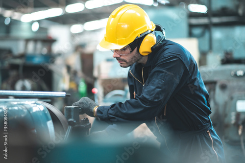 Industrial Engineers in Hard Hats.Work at the Heavy Industry Manufacturing Factory.industrial worker indoors in factory. man working in an industrial factory.Safety first concept.