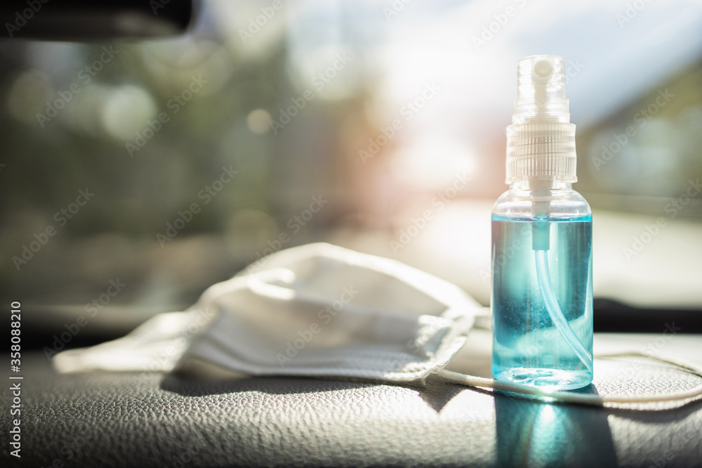 Travel and vacations concept,Medical mask,hand sanitizer spray placed on console inside the car,preparation of portable disinfecting alcohol spray,prevention of Covid-19,health care,new normal life Travel and vacations concept,Medical mask,hand sanitizer spray placed on console inside the car,preparation of portable disinfecting alcohol spray,prevention of Covid-19,health care,new normal life