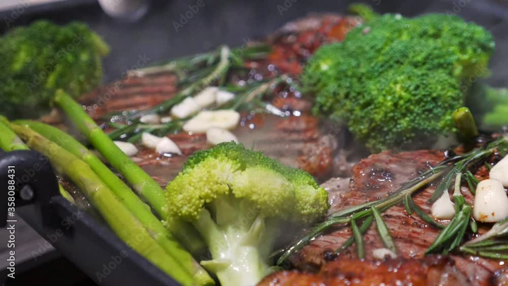 Cooking beef and vegetables on grill frying pan on gas oven. closeup. Nobody Cooking beef and vegetables on grill frying pan on gas oven. closeup. Nobody